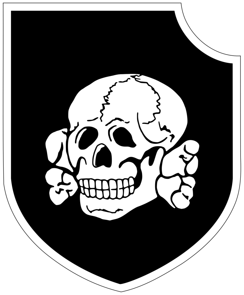 Emblema da 3ª Divisão SS Totenkopf, representando um crânio humano com tíbias cruzadas atrás, sobre um escudo preto com contorno branco.